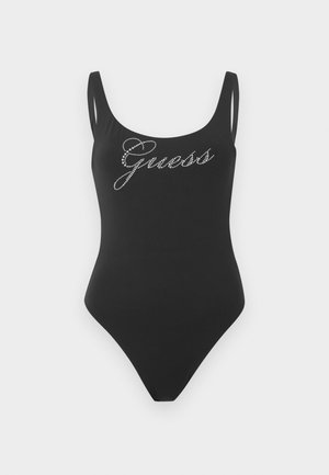 Must ühes tükis ujumistrikoo õhukeste õlapaeltega ja rinnal kivikestest "Guess" logo.