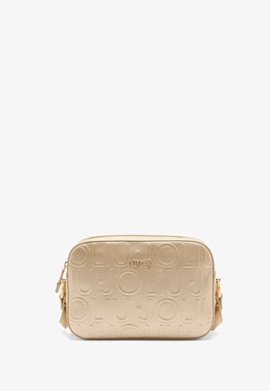 Beige faux leather crossbody bag with embossed logo pattern, zip closure, and a detachable strap. Features smooth texture and gold-tone accents.