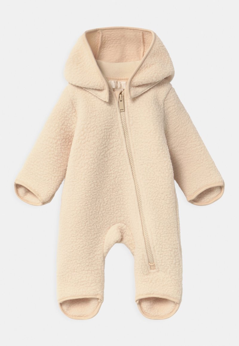 Grenouillère bébé en polaire couleur crème avec capuche, manches longues et fermeture éclair à l'avant, conçue pour la chaleur et le confort.