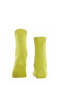 Gelbe Socken aus weichem Stoff, mit einem gerippten Bündchen, glatter Textur und einem einfarbigen Muster ohne zusätzliche Designs oder Akzente.