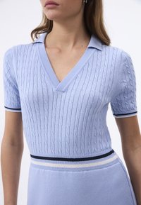 Helles blaues Kurzarmkleid mit V-Ausschnitt, Kabelstrick-Textur, marineblauen und weißen gestreiften Akzenten an den Ärmeln und der Taille.