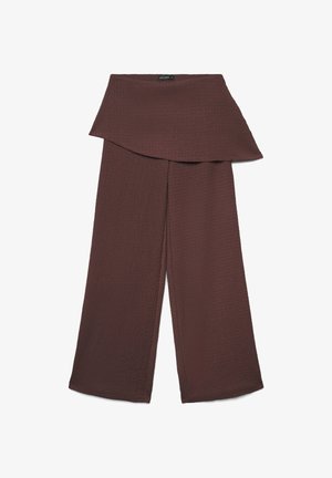 Brown wide-leg pants with textured fabric and an asymmetrical, layered waistband detail.
