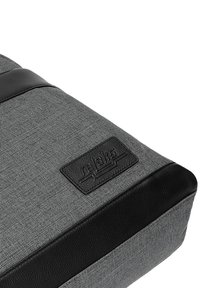 Borsa di tessuto grigio con superficie testurizzata, dettagli in pelle nera e logo in rilievo. Presenta una forma rettangolare e un design con materiali a contrasto.