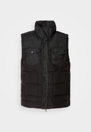 Black padded vest with a dark denim upper, high collar, and two chest pockets. Features snap buttons and a smooth texture.