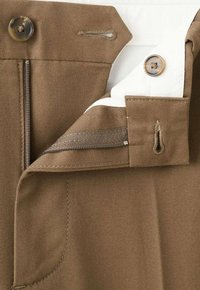 Brown trousers with a smooth texture, featuring a zip and button closure at the waist, and white internal lining with stitching details.