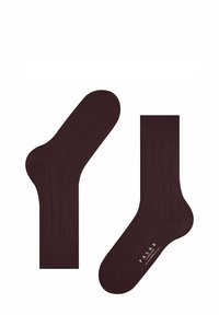 Brune strikkede sokker med ribbet tekstur, der har en fleksibel kant. Designet inkluderer diskret branding på sålen.