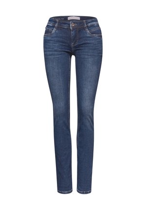 Jeans aderenti in denim blu scuro con una texture liscia. Presentano cinque tasche e una chiusura con bottone frontale. Dettaglio della cucitura a contrasto.