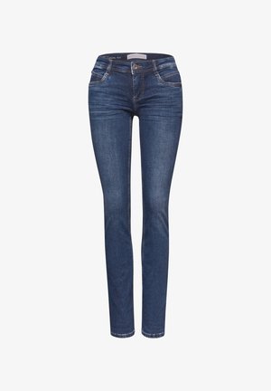 Jeans skinny en denim bleu foncé avec une texture lisse. Comprend cinq poches et une fermeture à bouton sur le devant. Détail de surpiqûre contrastée.