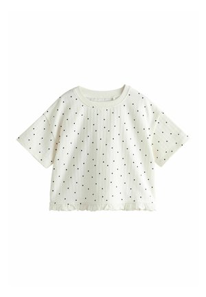 Hvid kortærmet cropped top med sorte polkaprikker og en flæsekant.