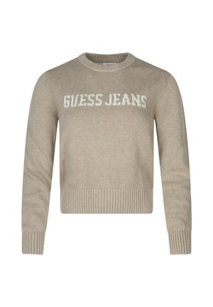 Pull court beige en tricot, avec un col et des poignets côtelés. Logo "GUESS JEANS" affiché en blanc.