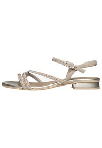 Beige sandal with three thin straps, metallic accents, and a low block heel. Features decorative studs along the strap edges.