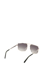 Gafas de sol de metal con montura plateada, lentes cuadrados que van de un gris oscuro a un gris claro y patillas acentuadas en verde. Almohadillas nasales ajustables para un mejor ajuste.