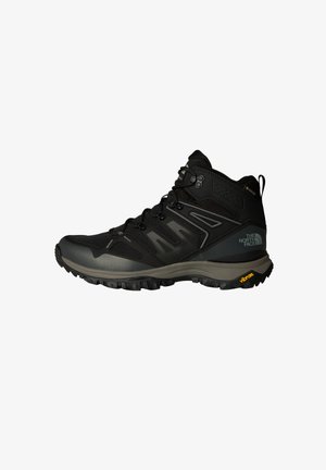 Mustad muste jalad, millel on võrgu ja sünteetiliste materjalide kattekiht, tekstureeritud vaheosa, Vibram tald ja hallid aksendid. Kõrge disain, mis toetab pahkluud.