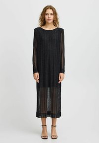 Rochie neagră cu mâneci lungi, cu un design cu dungi verticale, realizată dintr-un material transparent, ușor, cu particule metalice, ajungând până la jumătatea gambei.