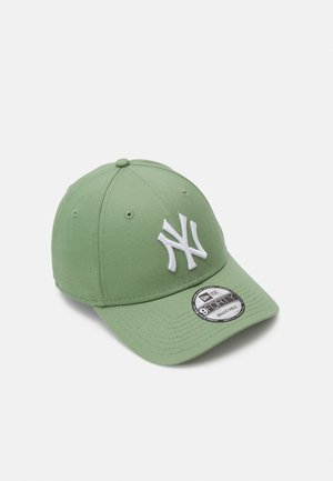 Green baseball cap made of fabric with a rounded crown, curved visor, and white embroidered NY logo on the front. Adjustable back strap.