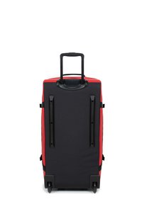 Wheeled suitcase with a red front and black exterior. Features a retractable handle and plastic hardware. Smooth texture and streamlined design.