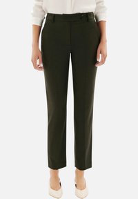 Pantalons ajustés vert olive, avec une coupe slim, dotés d'une texture lisse, de deux boutons et de poches latérales en biais.