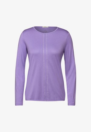 Violetti pitkähihaisen paita, joka on valmistettu pehmeästä kankaasta. Paidassa on pyöreä pääntie ja keskeinen sauman yksityiskohta. Liukas tekstuuri, rento istuvuus.