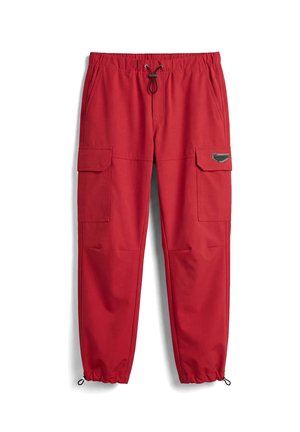 Pantalones cargo rojos con cintura elástica, cordones ajustables en la cintura y los tobillos, grandes bolsillos con solapa en los muslos y bolsillos en las costuras laterales.