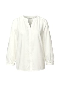 Camicia bianca a maniche lunghe con un motivo testurizzato, scollatura a V, chiusura con bottoni sul davanti e polsini elasticizzati. Realizzata in tessuto leggero.