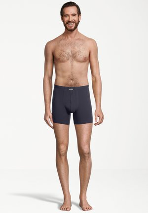 Boxer brev neri scuri con elastico in vita, caratterizzati da un'apertura frontale e un morbido tessuto misto cotone. Nessun motivo o dettaglio visibile.