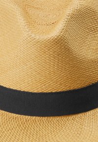Wide-brimmed straw hat in light tan with a textured weave, featuring a solid black band around the base.