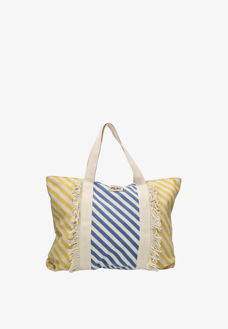 Bolso tote a rayas en amarillo y azul con detalles de borlas. Tela de algodón, forma rectangular, asas dobles y una etiqueta en la parte frontal.