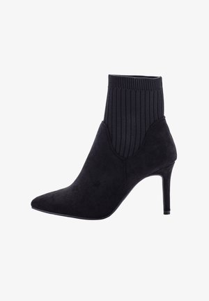 Black suede pointed-toe ankle boot with ribbed knit sock upper and slim high heel.