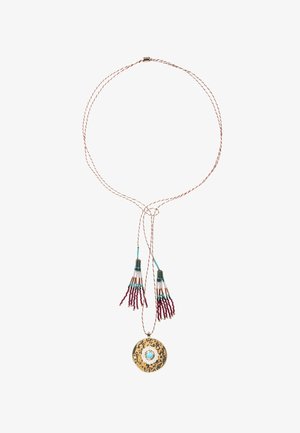 Gold-toned long necklace with a textured circular pendant and tassel accents in red and turquoise beads, on a twisted cord.
