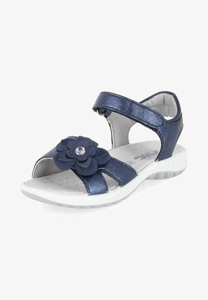 Sandale enfant bleu marine avec semelle blanche, bride réglable à la cheville et décoration fleurie avec une petite pierre sur la bride avant.