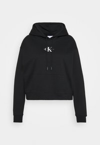 Sudadera negra de mezcla de algodón con bolsillo canguro, capucha con cordón y logo blanco de Calvin Klein. Puños y dobladillo acanalados.