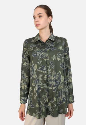 Long-sleeve blouse in dark green fabric with a floral pattern in light green and blue. Features a collared neckline and button front.