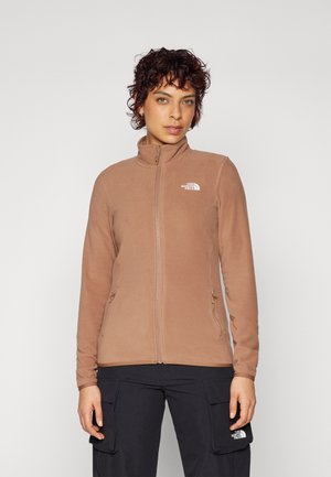 Brown fleece jacket with a high collar, front zip, and two zippered side pockets. Features a white logo on the left chest.
