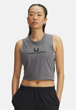 Gray cropped tank top with "UNDER ARMOUR" logo in black. Smooth cotton blend fabric, sleeveless design, and crew neck. Paired with black pants.