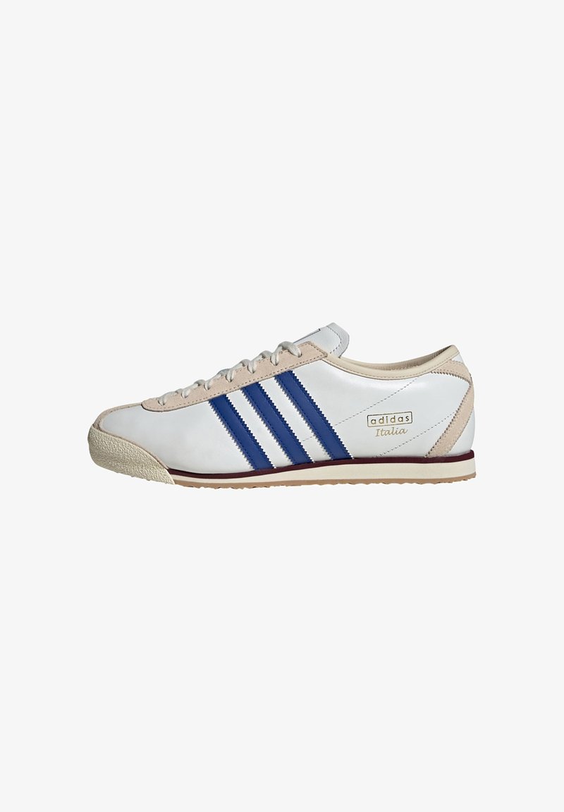 White leather sneaker with blue stripes, beige accents, and a textured rubber sole. Features a lace-up design and branding on the side.