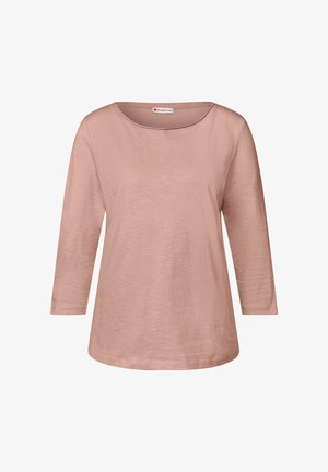 Lys rosa langærmet skjorte med rund halsudskæring og afslappet pasform. Glat tekstur med en subtil glans og afrundet kant. Brandlabel synlig.