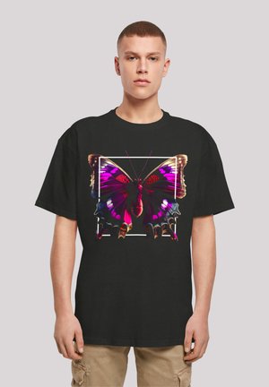 Black t-shirt featuring a large, detailed graphic of a butterfly in purple and pink hues, framed by a white rectangle. Short sleeves, relaxed fit.