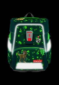 Grüner Rucksack mit reflektierenden Akzenten, verziert mit einem Dinosaurier-Motiv und einem Muster aus hellgrünen geometrischen Formen. Reißverschluss und Logodetail sichtbar.