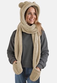 Fleecehalstørklæde og hætte i lys beige, med bjørneører, lang design og håndlommer. Blød tekstur med et hyggeligt udseende.