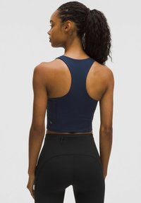 Navy blue athletic crop top with a racerback design, made from smooth material. Features a small logo detail on the back.
