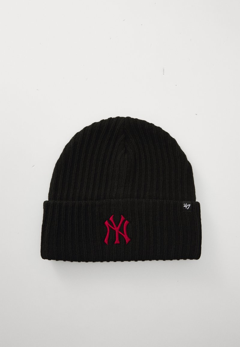 Black ribbed beanie with a folded cuff. Features a bright pink embroidered logo on the front and a small black tag on the side.
