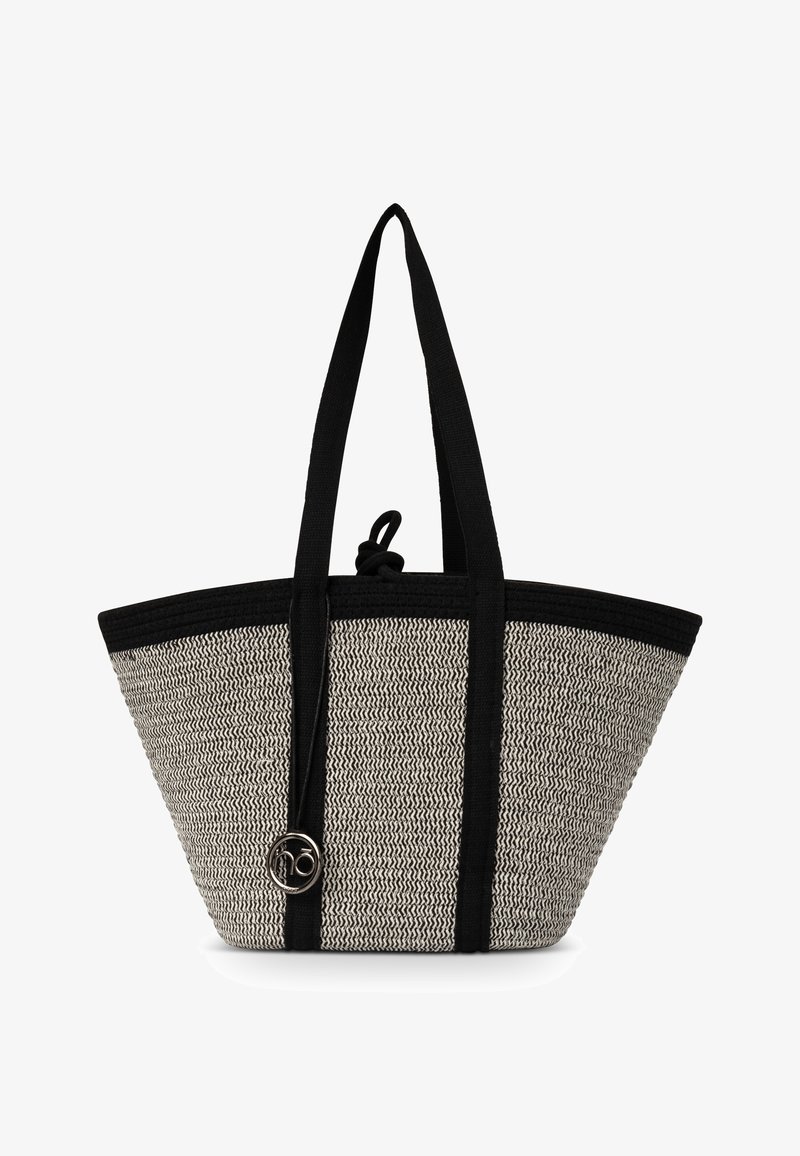Sac cabas tissé noir et blanc avec de longues poignées noires et un petit logo circulaire argenté près du bas au centre.