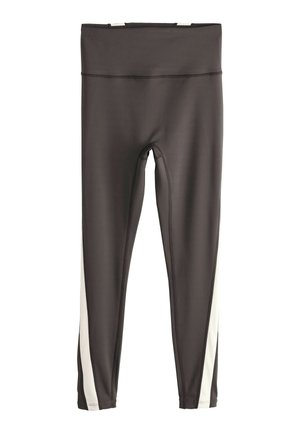 Sorte leggings med høj talje og hvide lodrette striber langs ydersiden af begge ben, vist fladt på en hvid baggrund.