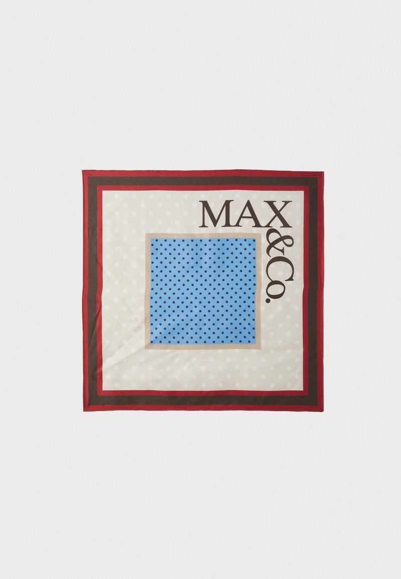 Silk scarf featuring a light beige background with white polka dots, a blue square with black dots, bordered by red and brown edges, and branded text.