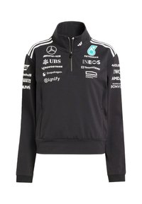Schwarzer Quarter-Zip-Pullover mit hohem Kragen, verfügt über weiße Streifen und mehrere Logos auf der Vorderseite. Hergestellt aus glattem, dehnbarem Stoff.