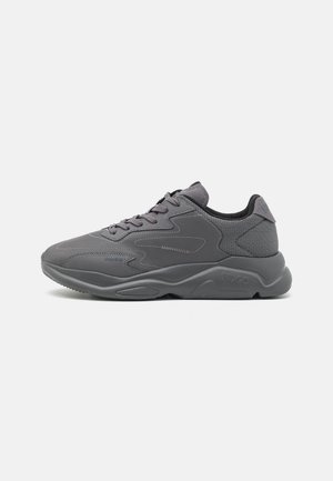 Dark gray athletic sneaker with mesh and synthetic upper, lace-up closure, cushioned sole, and subtle "HUGO" branding on side and heel.