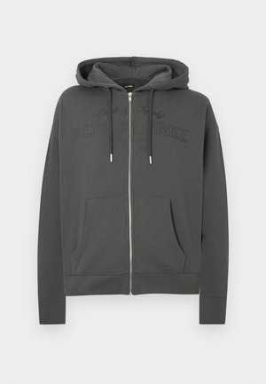 Sivá mikina na zips z mäkkej látky, s klokanie vrecko, kapucňou na šnúrku a vyrazeným logom "ALTA FLOREZ" na hrudi.