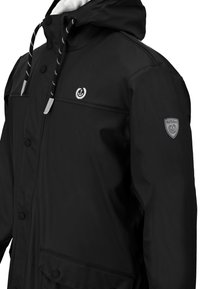 Black waterproof jacket with a zippered hood, snap buttons, two front pockets, white lining, and logo accents on chest and sleeve.