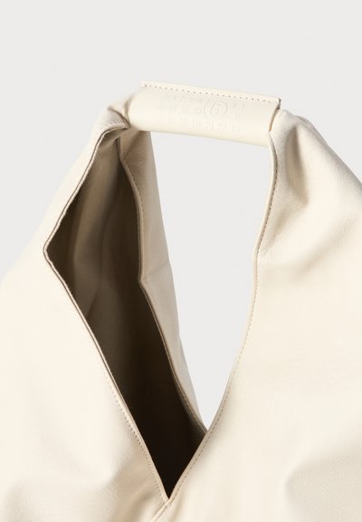 Bolsa de couro bege com uma abertura em forma de V e textura suave. A alça tem um design numérico estampado para um detalhe adicional.