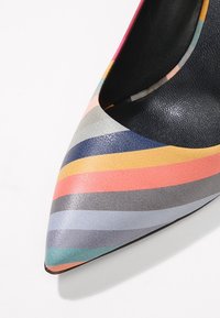 Multicolored pointed-toe pump with smooth leather upper, featuring horizontal stripes in pink, blue, gray, and gold. Black interior lining.